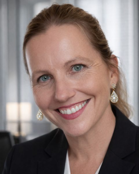 Nicole Wren, psychologist, smiling, in a dark blazer